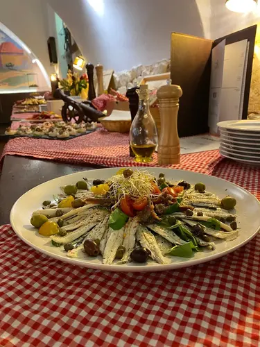 A chef preparing a dish in the kitchen